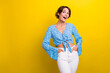 © deagreez - Photo of cheerful excited young lady dressed flower print top looking empty space isolated yellow color background
