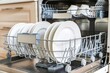 © Yuliia - Modern dishwasher kitchen household dish washing machine professional restaurant cafe equipment consumer grade heavy load home routine clean plates cups appliances loading unloading water technology