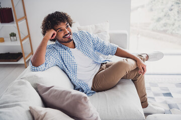 Wall Mural - Photo of dreamy good mood man wear checkered shirt staying home relaxing couch indoors house apartment room