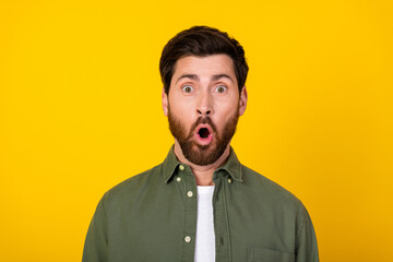 Sticker - Photo of nice young man staring wear khaki shirt isolated on yellow color background