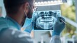© Alena Bekas - Dentist analyzing x-ray of teeth