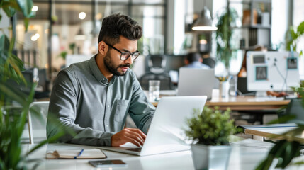 Wall Mural - a Hispanic entrepreneur working on a startup project in a bright, open-plan office