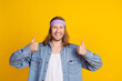 © deagreez - Photo portrait of attractive young hippie man show double thumb up wear trendy denim outfit isolated on yellow color background