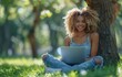© yevgeniya131988 - Young woman sits under a tree in a summer park, smiling while using a laptop, wearing casual attire