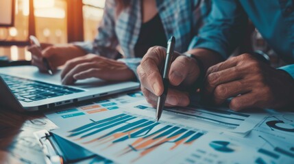 Poster - A financial planner reviewing stock market performance with a client while pointing to a stock market graph on a paper report