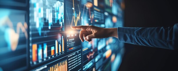 Useful for business presentations or financial reports, this image shows a person interacting with a futuristic digital data interface with graphs and charts.