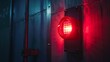 © stockpro - Dimly lit industrial setting with a glowing red warning light on a metallic wall, emphasizing safety, caution, and alertness in work environments.