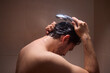© Евгений Вершинин - A man is taking a shower, enjoying the clean water to ensure good hygiene and relaxation