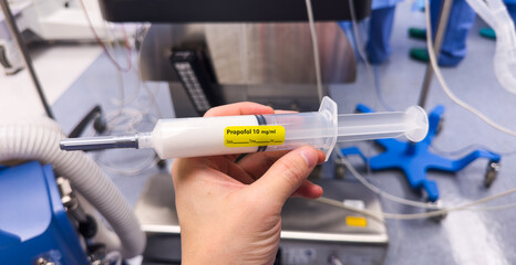 medical syringes with anesthetic drugs - propofol, midazolam, fentanyl - arranged on sterile tray in hospital setting