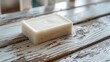© The 2R Artificiality - Soap brick resting on a wooden table with a white finish