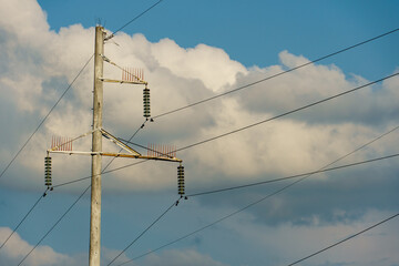 Wall Mural - Power lines and high-voltage wires against a background of blue sky and fluffy clouds. Energy infrastructure of Ukraine.