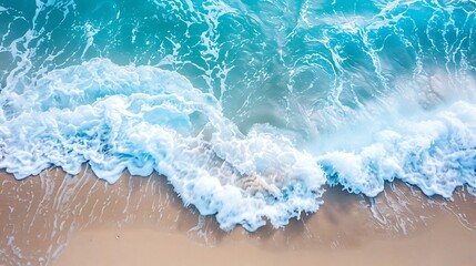 The photo shows the beach sand and the blue ocean wave.