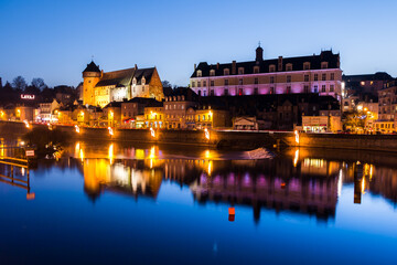 Wall Mural - Scenic view of the historic laval town and castle reflected on the calm river at dusk
