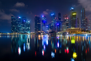 Wall Mural - City skyline at night with water reflections