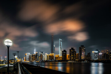 Wall Mural - Majestic city skyline at night by the waterfront