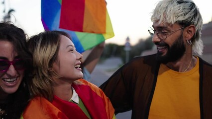 Wall Mural - A happy crowd of LGBT people wearing colorful smiling for a picture with a rainbow flag at a fun pride day parade event. They exude leisure and travel vibes. Community and friendship