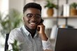 © Sandu - Happy man in eyewear using cellphone at desk