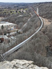 Sticker - Train passing through lush forested mountain scenery