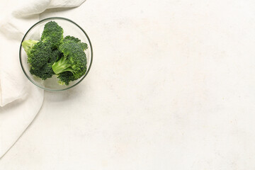 Wall Mural - Glass bowl with fresh broccoli cabbages on white background