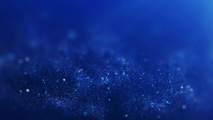 Poster - Abstract blurred sparkling or glittering particles on dark blue background.