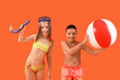 © Pixel-Shot - Cute little children in swimsuit with beach ball and snorkeling mask on orange background