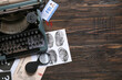 © Pixel-Shot - Retro typewriter, criminal files and document of FBI agent on dark wooden background
