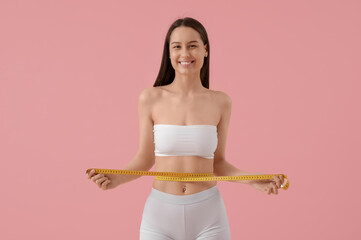 Sticker - Beautiful young happy woman with measuring tape on pink background. Weight loss concept