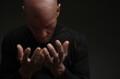 © herlanzer - praying to god with hands together on dark background stock photo