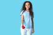 © Pixel-Shot - Young female African-American blood donor with applied medical patch and heart on blue background