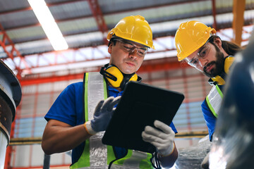 two young caucasian workers using digital tablet to check product stock at the product drop-off poin