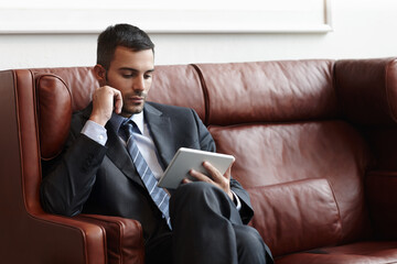 Aufkleber - Reading, tablet and businessman on couch for online, research and email in waiting room. Trader, stock market and internet with technology for planning and proposal for startup company in New York