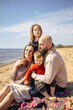 © DariaTrofimova - Portrait of  loving family of parents and daughter with son on  beach by   sea