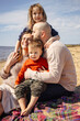 © DariaTrofimova - Portrait of  loving family of parents and daughter with son on  beach by   sea