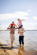 © DariaTrofimova - Sunny portrait of  loving family of parents and daughter with son on  beach by  sea