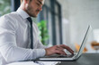 © Adene Sanchez/peopleimages.com - Hands, laptop and report with business man typing at desk in office for email, feedback or review. Administration, computer and research with employee in workplace for management or planning