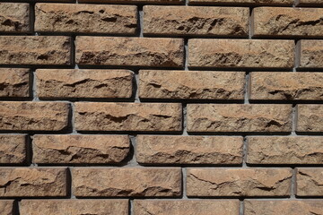 Canvas Print - Front view of brown split face brick veneer wall with stretcher bond pattern