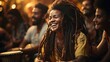 © AS Photo Family - Joyous musician with dreadlocks playing a djembe drum during a vibrant music session