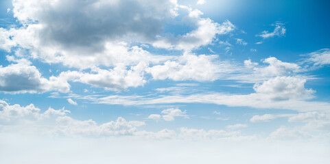 Wall Mural - a bright fresh sunny spring, summer blue sky background with white fluffy clouds.