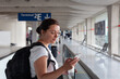 © Song_about_summer - woman in airport, passenger using mobile app on the phone