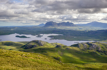 Sticker - Views of the summits of Suilven, Caisteal Liath with Loch Sionasgaig below from the summit of Stac Pollaidh in the Scottish Highlands on a sunny summers day with dramatic clouds in the UK