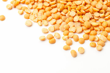 Wall Mural - Split yellow peas pile on white background. Dry peas grains