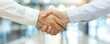 © narak0rn - Close-up of a professional handshake between two businesspeople in formal attire, symbolizing partnership, agreement, or successful negotiation.