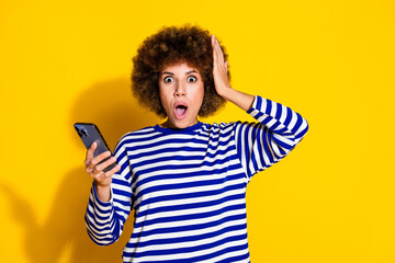 Canvas Print - Photo of nice young girl open mouth hold smart phone wear striped shirt isolated on yellow color background