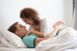© themorningglory - Love couple lying on white bed in morning happy and carring together