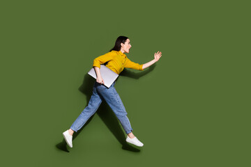 Canvas Print - Full length photo of charming positive woman wear yellow shirt holding modern gadget jumping high isolated khaki color background