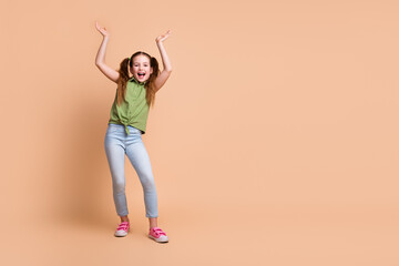 Poster - Photo of positive cheerful girl kid stand empty space moving dance isolated pastel color background