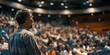 © Anastasiia - Engaging Speaker Holds Audience's Attention in Packed Hall During Presentation. Concept Public Speaking, Audience Engagement, Presentation Skills, Captivating Speaker, Effective Communication