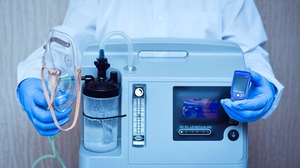 hands in medical gloves hold an oxygen mask from the generator oxygen concentrator, which helps with