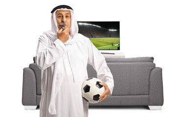 Sticker - Football match on tv and an rab man in ethnic clothes holding a ball and blowing a whistle