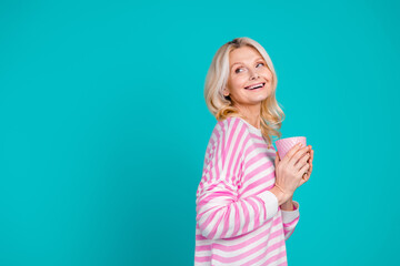 Sticker - Photo of adorable woman with blond hair wear striped shirt holding mug of coffee look empty space isolated on blue color background